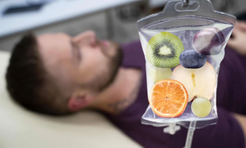 Man receiving IV Therapy in Riverside, CA with a nutrient-rich infusion bag containing fruits symbolizing vitamins and hydration.