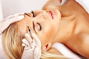 Beauty woman giving botox injections.